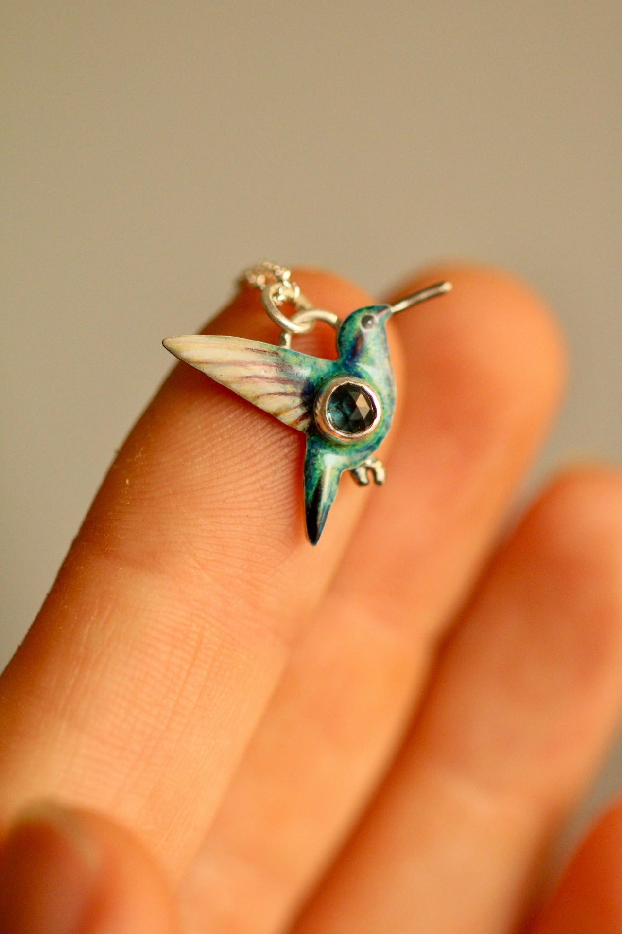 Hummingbird pendant with blue sapphire