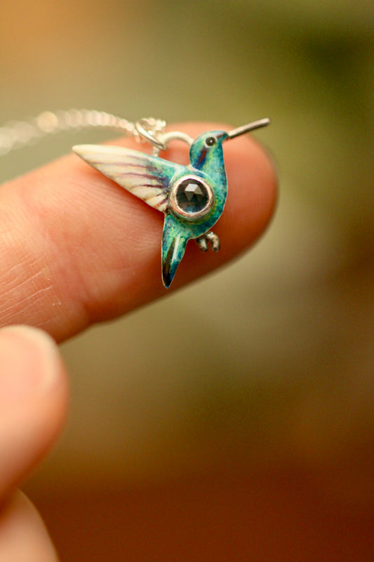 Hummingbird pendant with blue sapphire