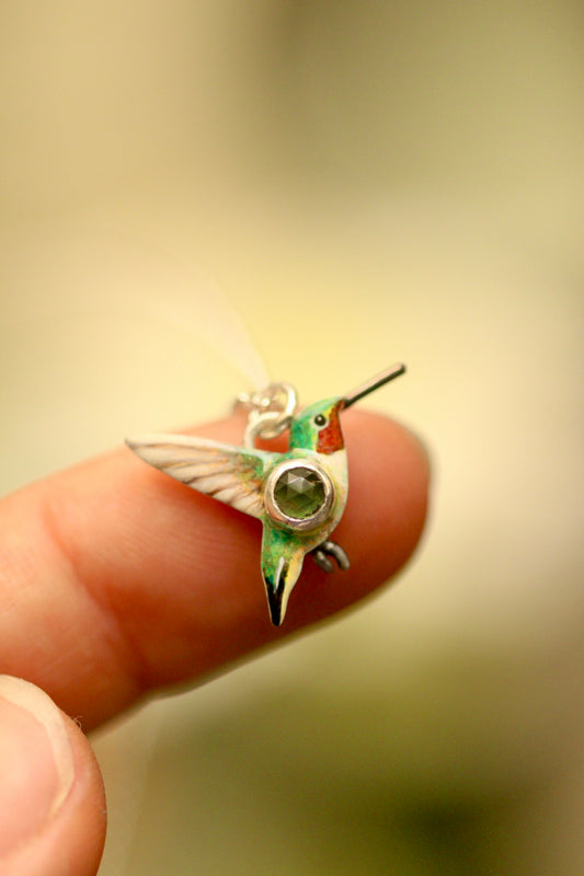 hummingbird pendant with green sapphire