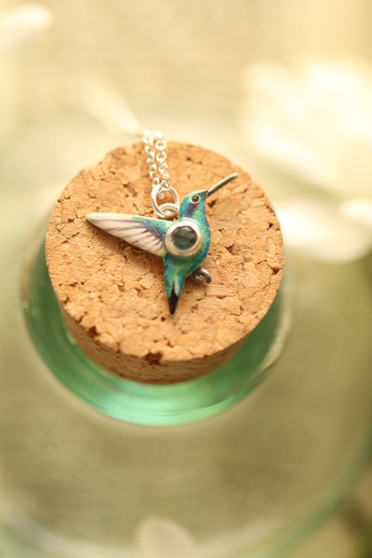 hummingbird pendant with green sapphire